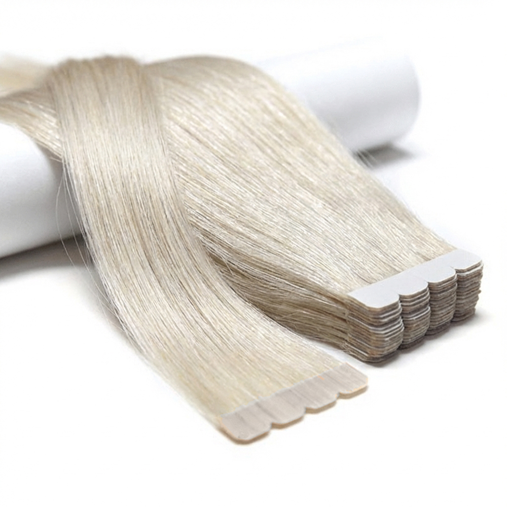 Products Extreme close-up of premium 100% virgin remy cuticle human hair M-tape injected extensions with scalloped edges in icy blonde for B2B wholesale salons.